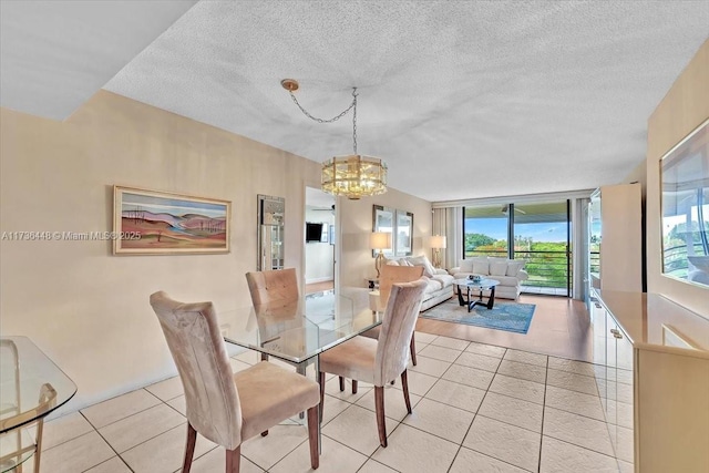 tiled dining room featuring an inviting chandelier, expansive windows, and a textured ceiling