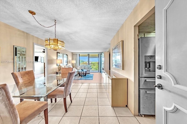 dining space featuring light tile patterned flooring and a textured ceiling