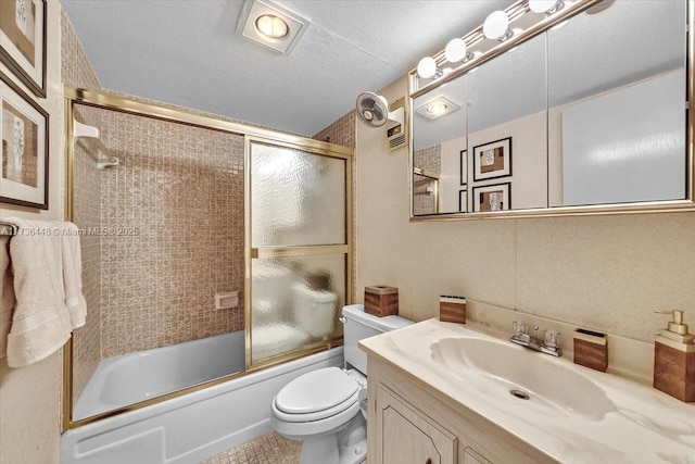 full bathroom with vanity, a textured ceiling, enclosed tub / shower combo, and toilet