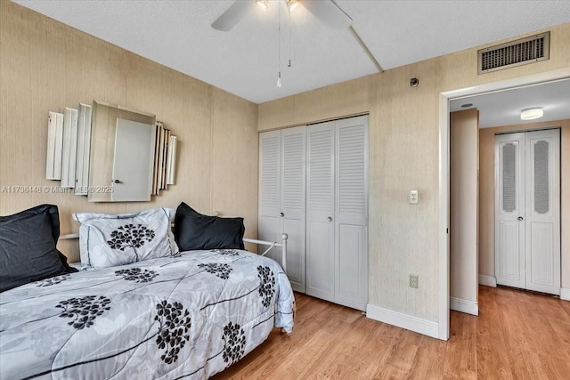 bedroom with a closet, ceiling fan, and light wood-type flooring