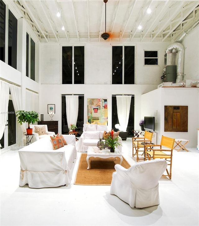 living room featuring a towering ceiling