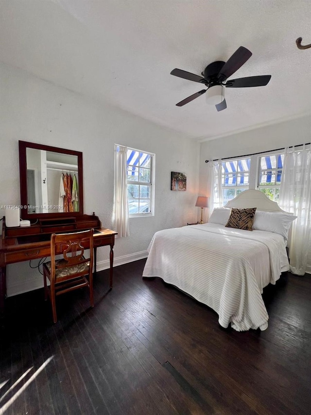 bedroom featuring ceiling fan and dark hardwood / wood-style flooring