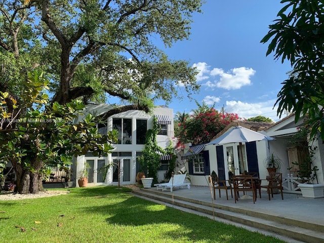 view of yard with french doors and a patio area