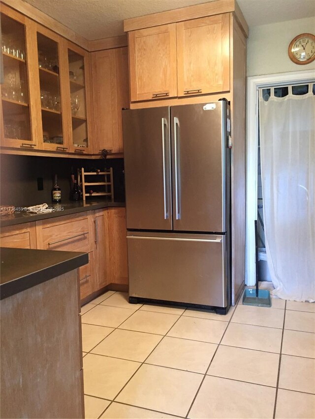 kitchen with stainless steel refrigerator and light tile patterned flooring