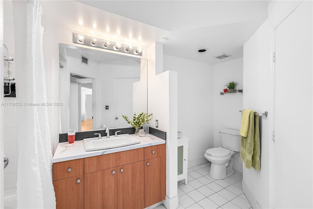 bathroom featuring vanity, tile patterned floors, and toilet