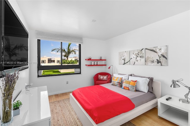 bedroom with wood-type flooring