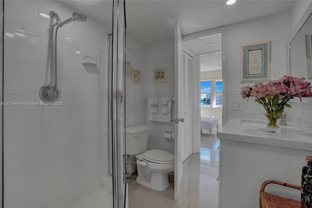 bathroom featuring vanity, an enclosed shower, tile patterned floors, and toilet