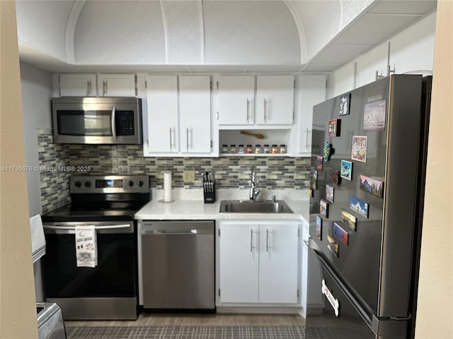 kitchen featuring appliances with stainless steel finishes, sink, and white cabinets