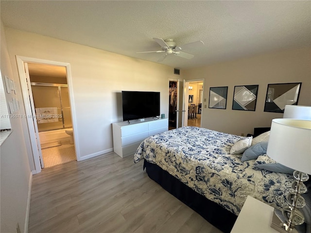 bedroom with hardwood / wood-style flooring, ceiling fan, and a textured ceiling