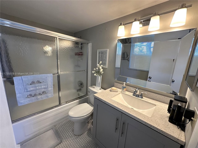 full bathroom with shower / bath combination with glass door, vanity, toilet, and tile patterned flooring