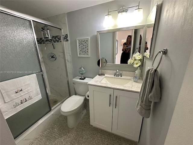 bathroom featuring walk in shower, vanity, and toilet