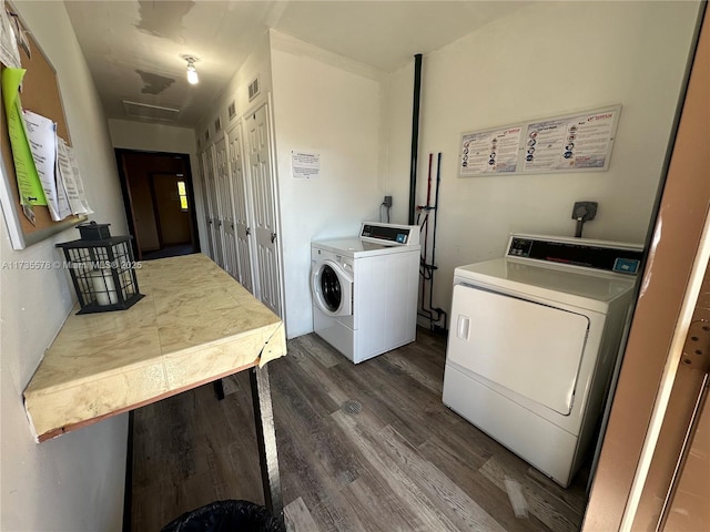 washroom featuring dark hardwood / wood-style floors and washing machine and clothes dryer