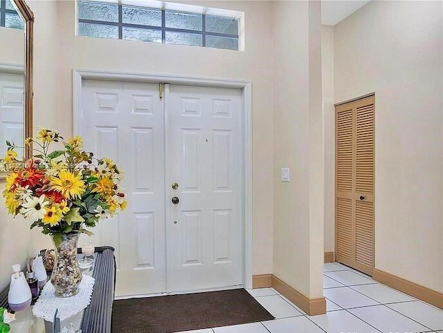 entrance foyer featuring a high ceiling and light tile patterned flooring