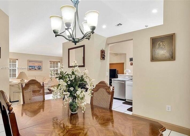 dining room with an inviting chandelier and light parquet floors