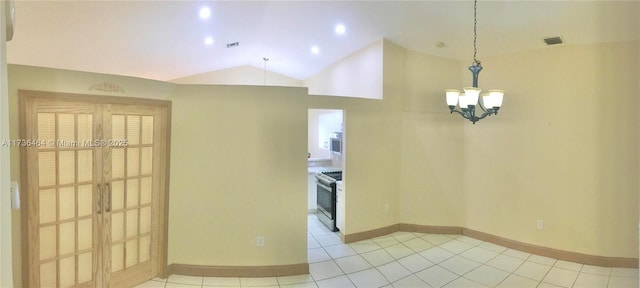 spare room with vaulted ceiling, a chandelier, and light tile patterned flooring