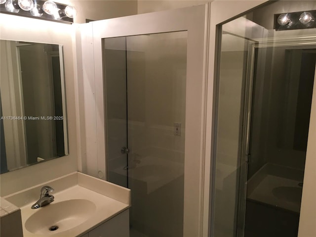 bathroom with vanity and a shower with shower door