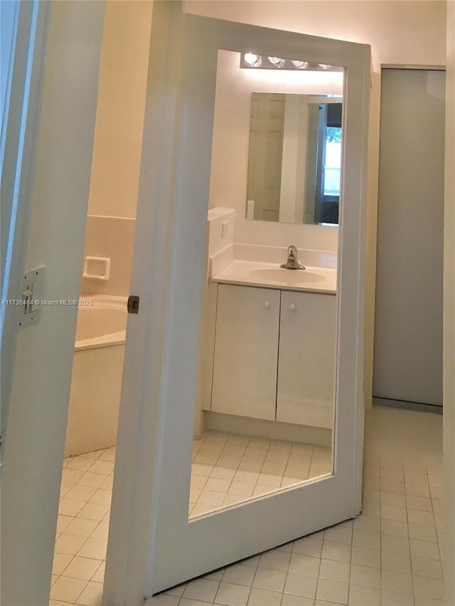 bathroom featuring tile patterned flooring and vanity