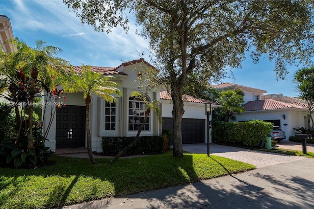 mediterranean / spanish home featuring a front lawn