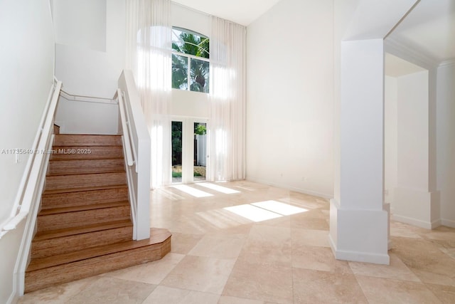 stairway featuring a high ceiling