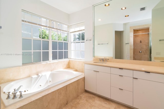 bathroom with vanity, shower with separate bathtub, and tile patterned flooring