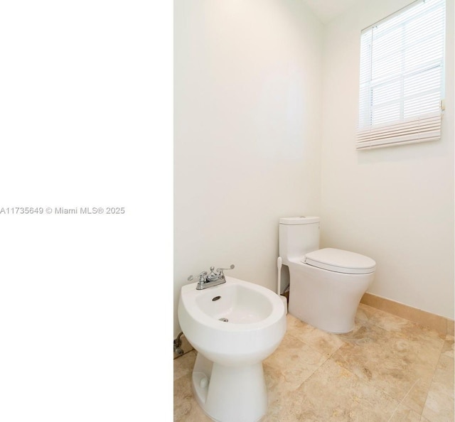 bathroom featuring a bidet and toilet