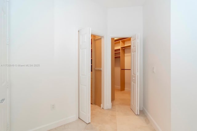 hall featuring light tile patterned flooring