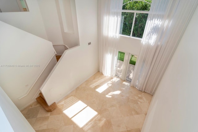 entrance foyer featuring a towering ceiling and french doors