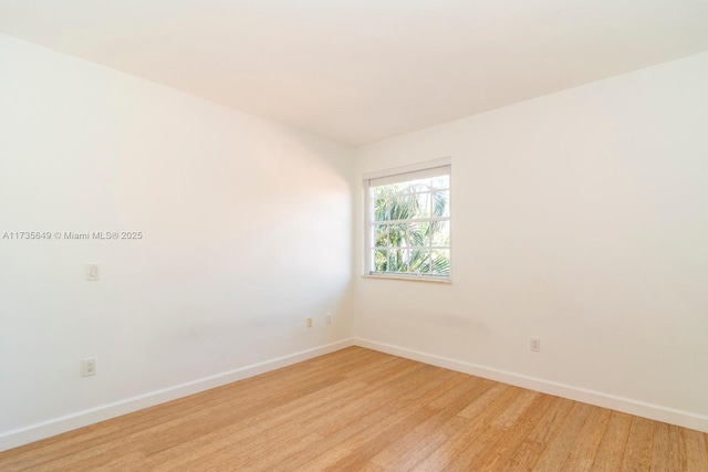 spare room featuring light hardwood / wood-style floors