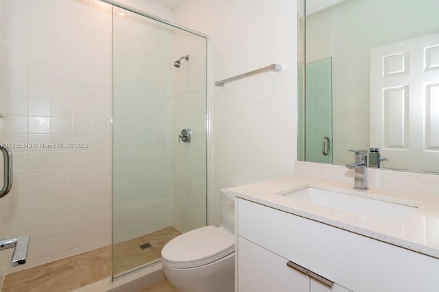 bathroom featuring vanity, toilet, and walk in shower