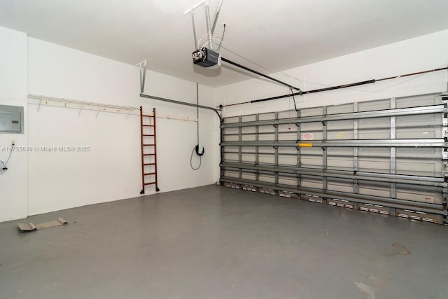 garage with a garage door opener and electric panel