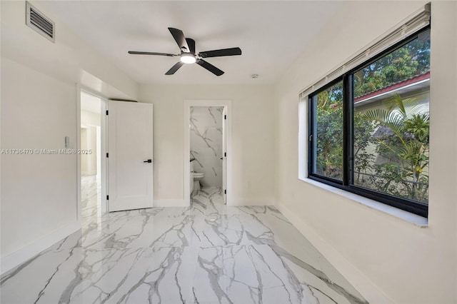 unfurnished bedroom with ceiling fan and ensuite bathroom