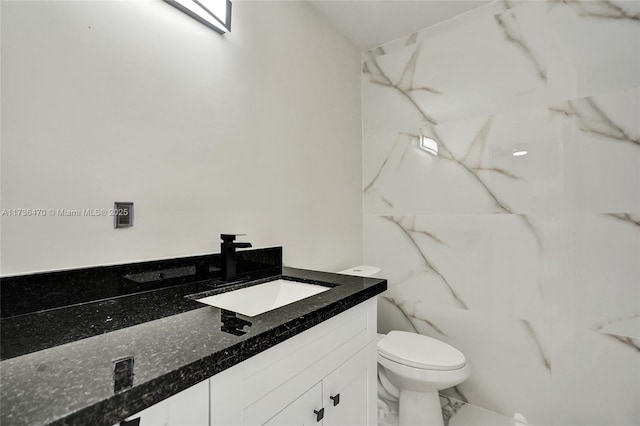 bathroom featuring vanity and toilet