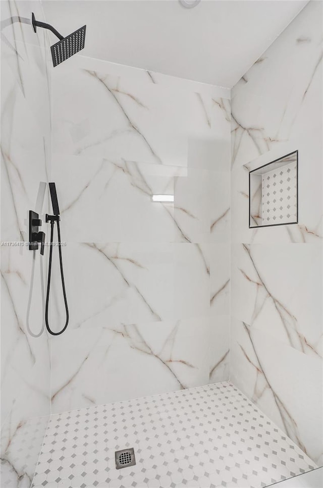 bathroom with a tile shower