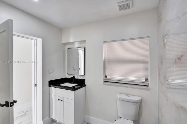 bathroom with vanity and toilet