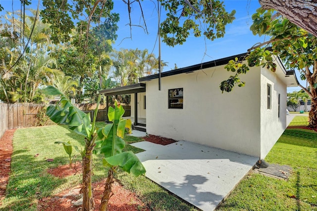 view of home's exterior featuring a patio area and a lawn