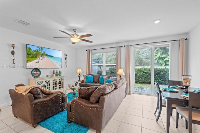 tiled living room with ceiling fan