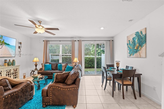 tiled living room featuring ceiling fan