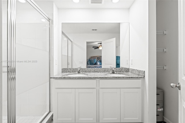 bathroom featuring ceiling fan, vanity, and an enclosed shower