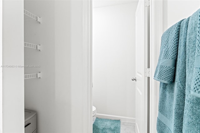 bathroom featuring toilet and tile patterned flooring