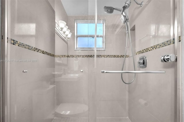 bathroom with a shower with shower door