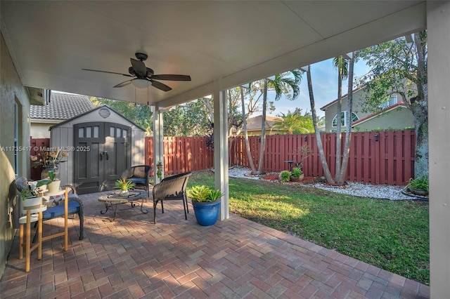 view of patio / terrace with ceiling fan and a storage unit