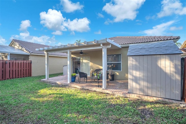 rear view of house featuring a yard, a patio, and ceiling fan