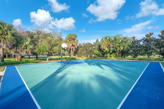 view of tennis court featuring basketball hoop