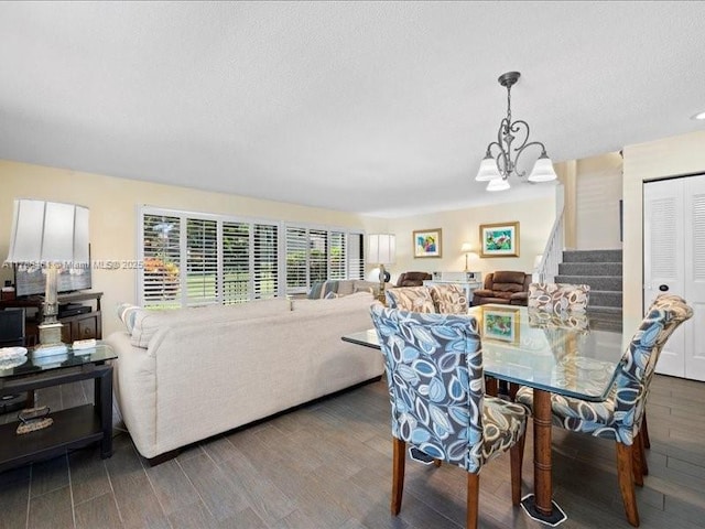 dining area featuring an inviting chandelier, dark hardwood / wood-style flooring, and a textured ceiling