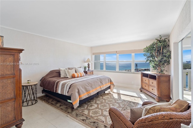 tiled bedroom featuring multiple windows and a water view