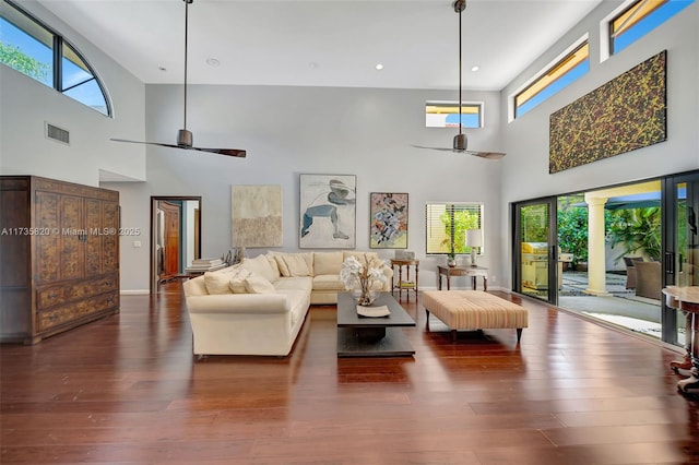 living room featuring dark hardwood / wood-style flooring, a healthy amount of sunlight, and ceiling fan