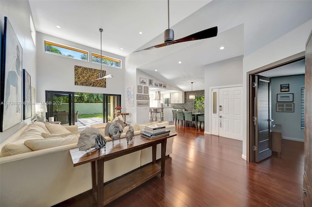 living room featuring dark wood-type flooring, ceiling fan, and high vaulted ceiling