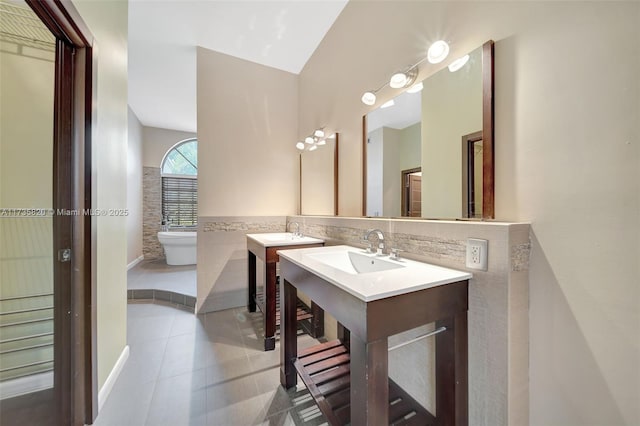 bathroom featuring tile patterned floors, toilet, tile walls, and vanity