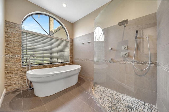 bathroom featuring tile patterned floors, independent shower and bath, and tile walls