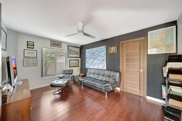 living area with wood-type flooring and ceiling fan